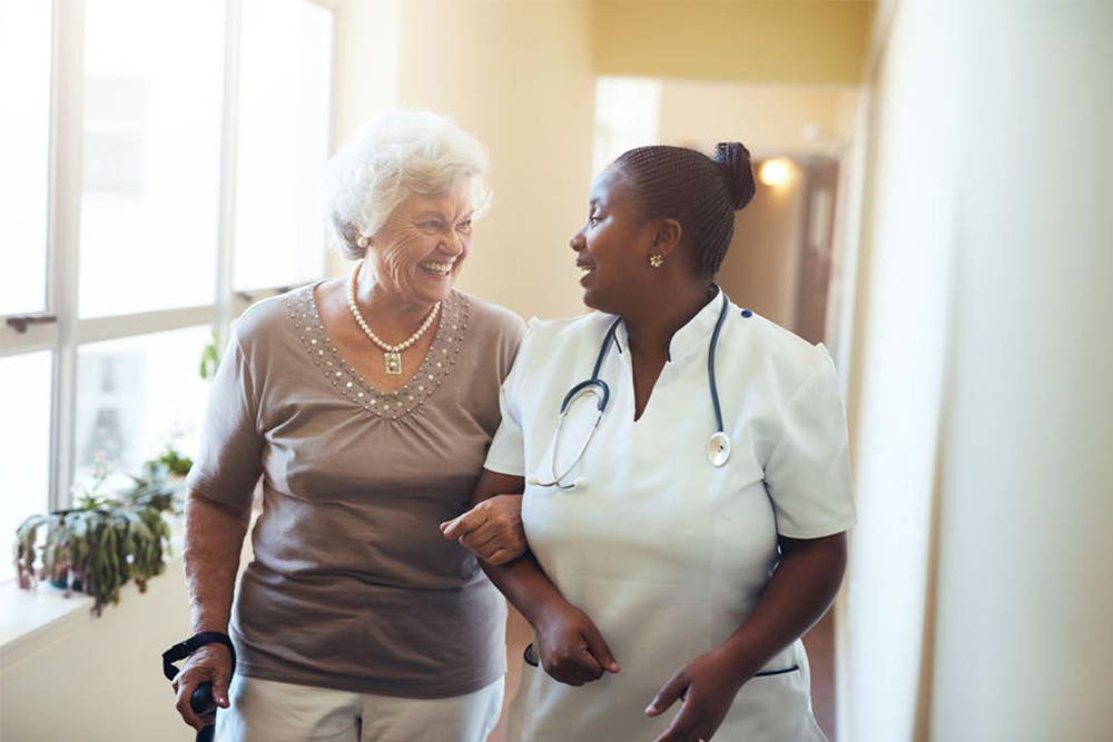 Caretaker walking with resident at Morningside Nursing and Rehabilitation Center.